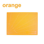 An orange cutting mat with a white grid and diagonal guide lines, shown on a white background with the word 'orange' in the top left corner.