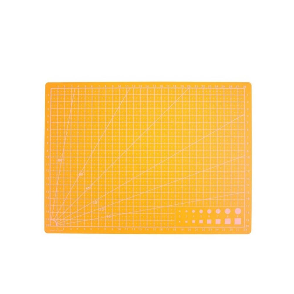 An orange rectangular cutting mat with a white grid, diagonal guide lines, and a small set of circular cutouts in the bottom right corner, shown on a plain white background.
