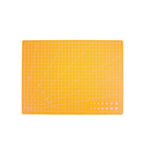 An orange rectangular cutting mat with a white grid, diagonal guide lines, and a small set of circular cutouts in the bottom right corner, shown on a plain white background.
