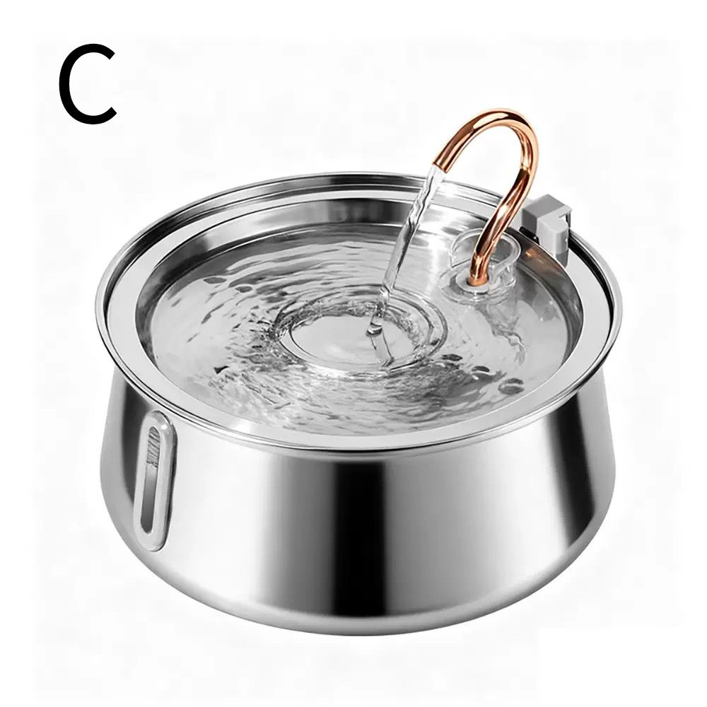 A stainless steel pet water fountain with a copper-colored handle and a clear water reservoir, shown with water flowing into the basin. A black letter 'C' is printed in the top-left corner on a white background.