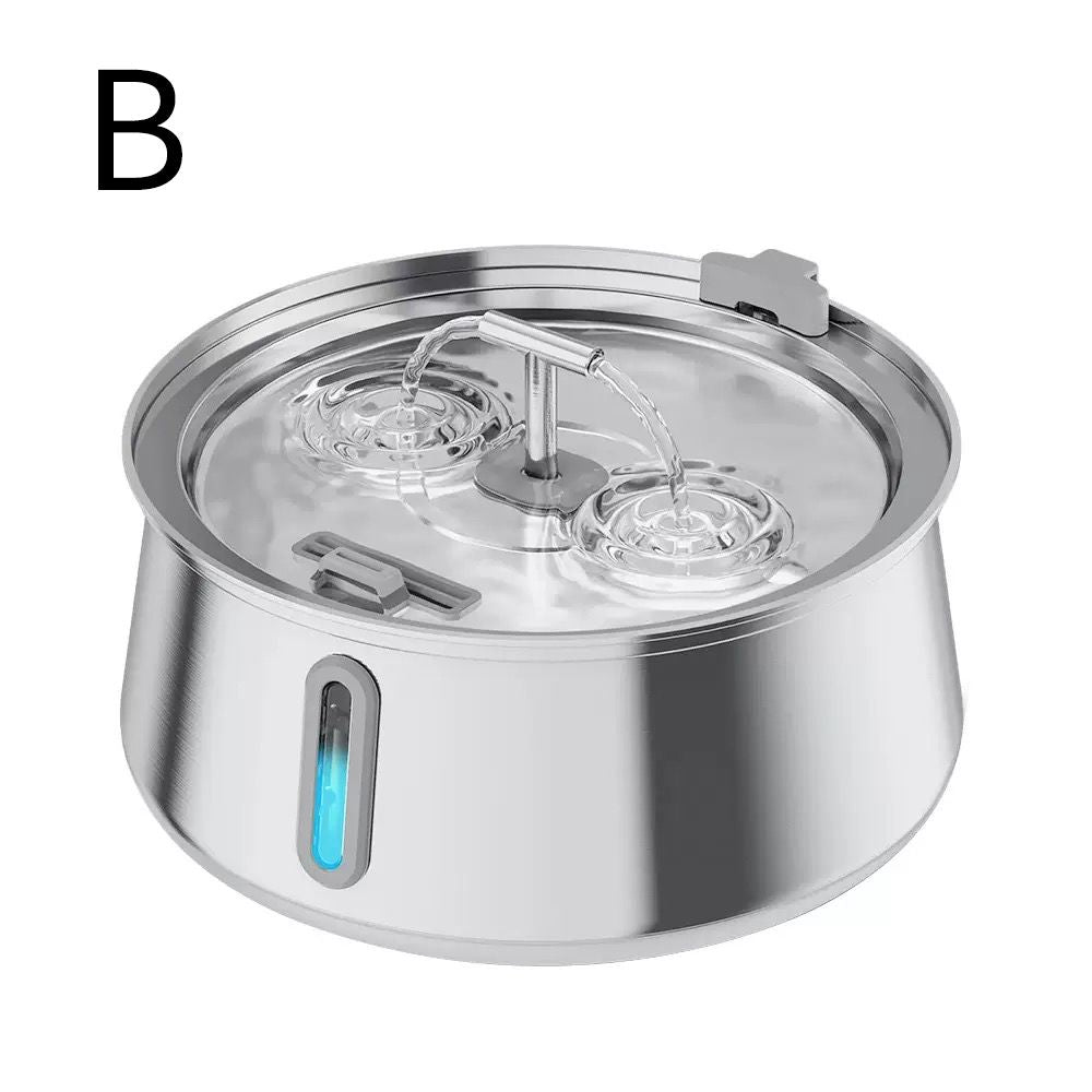 A stainless steel pet water fountain bowl with a clear glass lid, dual water jets, and a blue LED indicator light on the side, shown on a white background with a black letter 'B' in the top left.

Details