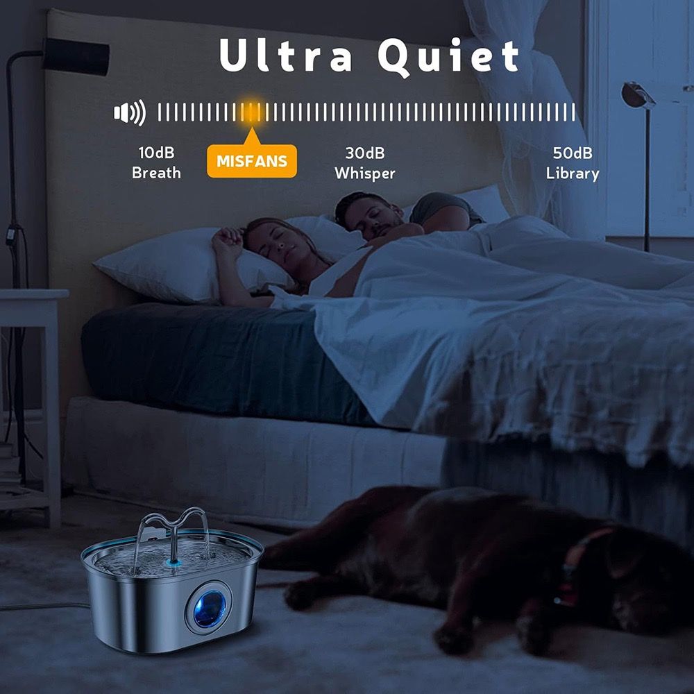 Sleeping couple with a dog in bed, featuring an ultra-quiet device on the floor.