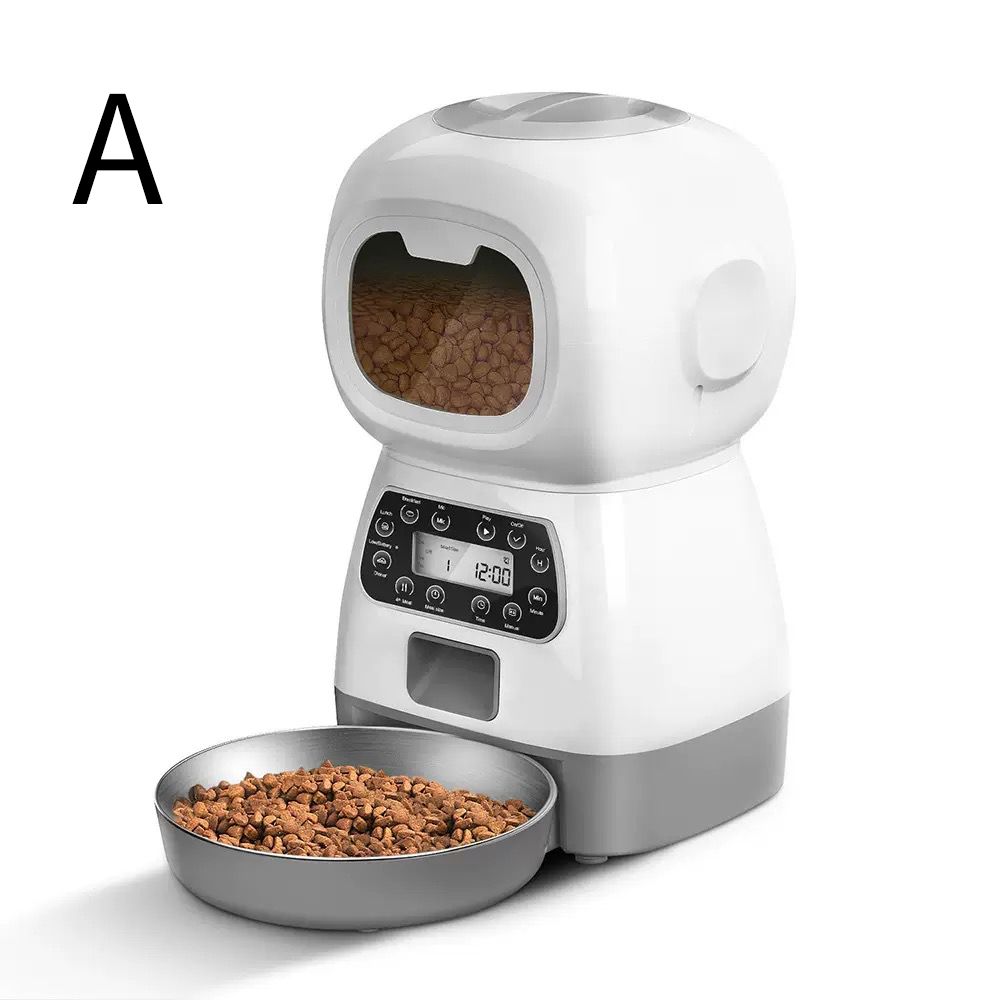 A white and gray automatic pet feeder with a digital control panel and a metal bowl of kibble in front, shown on a clean white background with a black letter 'A' in the top left corne