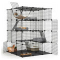 A large black wire multi-level cat playpen and climbing rack with doors, platforms, ramps, a hammock, and accessories, shown on a white studio background with a cat partially visible inside.