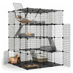 A large black wire multi-level cat playpen and climbing rack with doors, platforms, ramps, a hammock, and accessories, shown on a white studio background with a cat partially visible inside.