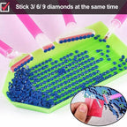 A diamond painting tray filled with blue faceted rhinestones, with three pink-handled pick tools depositing more stones. A text banner at the top reads 'Stick 3/6/9 diamonds at the same time,' and a circular inset shows a hand holding a tool over the tray.