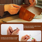 Person sewing a leather bag with a focus on thread and needle tools.