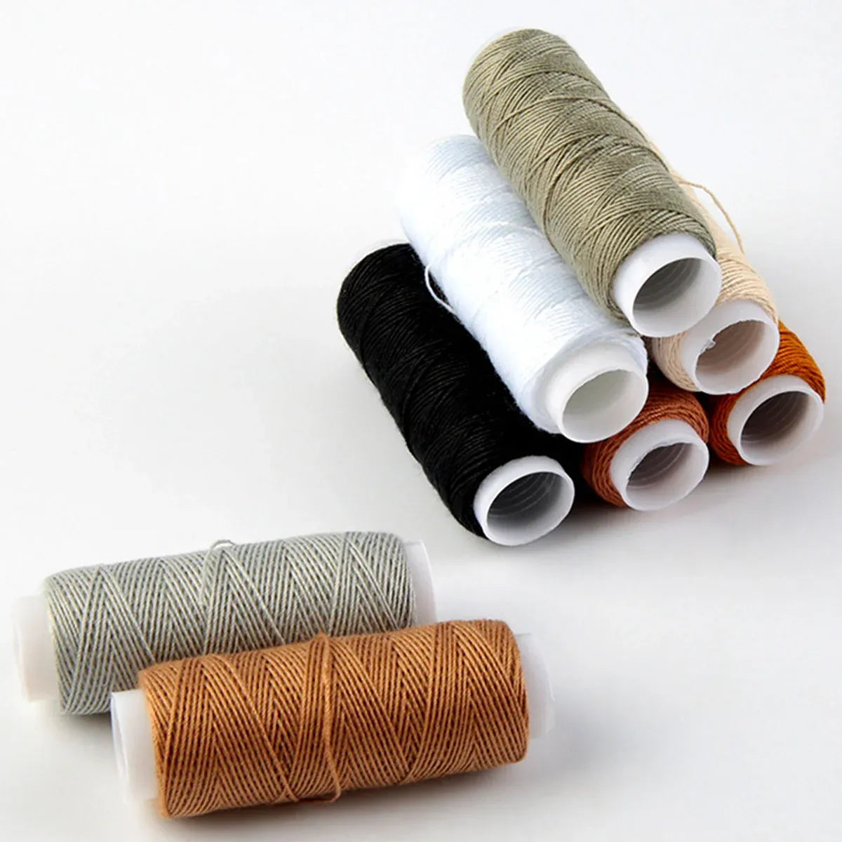 Set of spools of thread in various colors on a white background