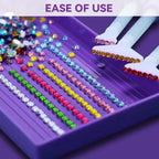 A close-up of a purple tray holding rows of colorful rhinestones, with two white-handled tools holding strands of colored rhinestones. Purple text at the top reads 'EASE OF USE'.