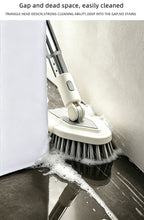 A close-up of a cleaning brush with a triangular head being used to clean the corner of a white cabinet and a dark countertop, with soapy foam visible. Text at the top describes the brush's cleaning advantages.
