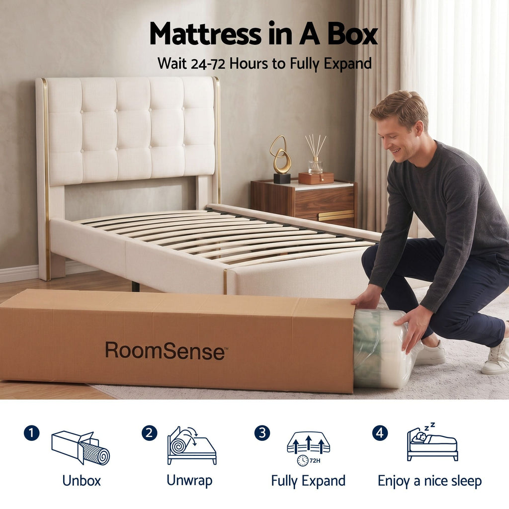 Person unpacking a mattress from a 'RoomSense' box in a bedroom setting.
