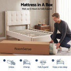 Person unpacking a mattress from a 'RoomSense' box in a bedroom setting.