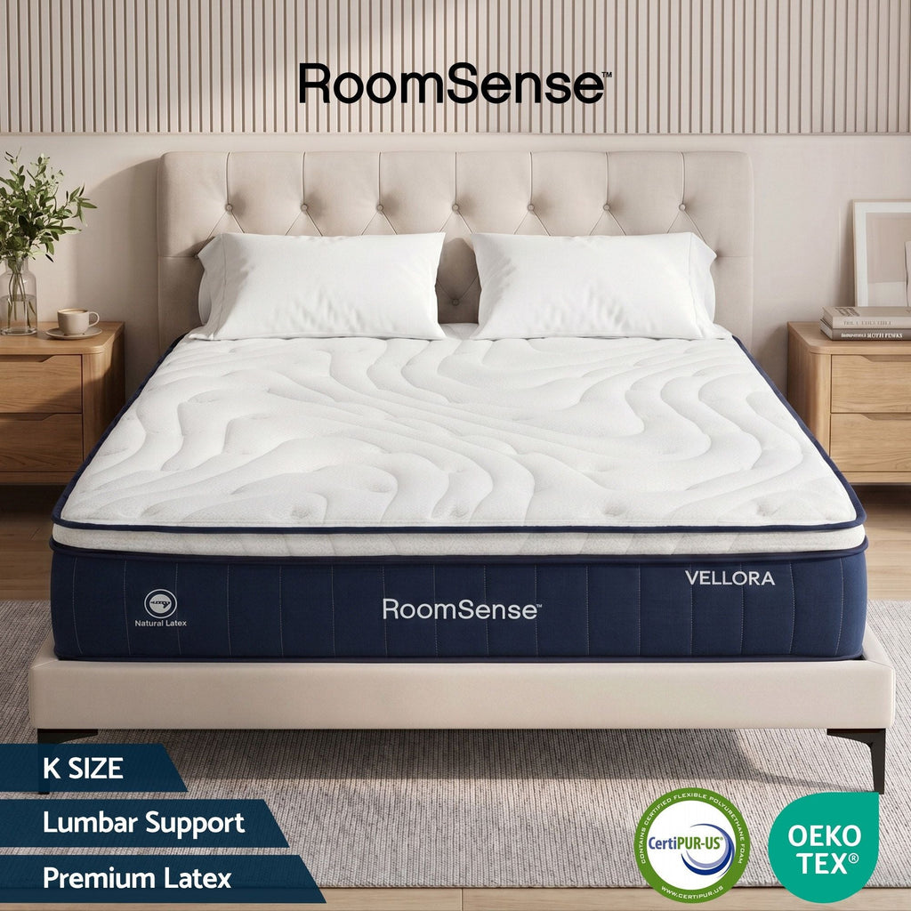 RoomSense Vellora mattress in a bedroom setting with 'CertiPUR-US' and 'OEKO-TEX' logos.