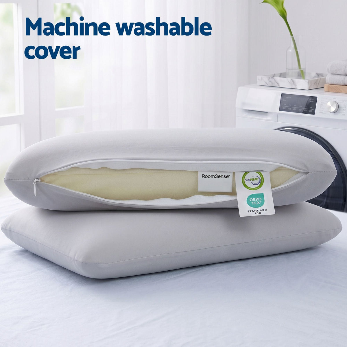 wo pillows with a machine washable cover on a bed next to a washing machine.