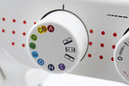 Close-up of a white sewing machine dial with colorful thread color indicators and stitch number markings, set against a white machine body with red dot accents.