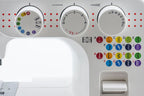 Close-up of a white sewing machine head showing three control dials, red dotted guide markings, and a grid of colorful stitch pattern icons labeled A through J.

Details