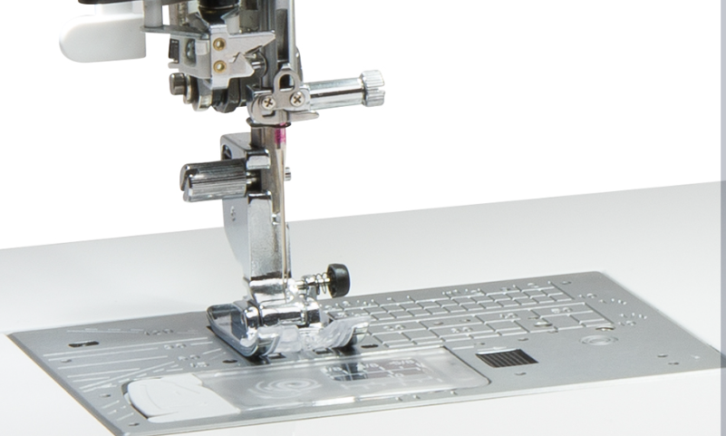Close-up of a sewing machine presser foot and metal plate assembly on a white background.