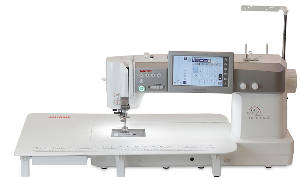 A white and gray Mahone M7 Continental commercial sewing machine with an integrated digital touchscreen display, shown on a clean white background and with extensio tabl added
