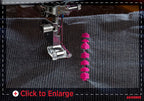 A close-up of a sewing machine needle and presser foot stitching dark gray fabric, with a vertical row of bright pink satin stitch embellishments being created. A 'Click to Enlarge' overlay is visible at the bottom.