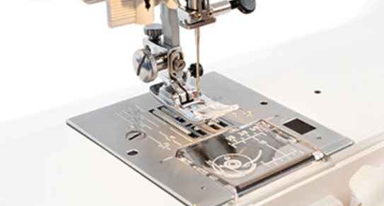 Close-up of a sewing machine needle and presser foot on a white background